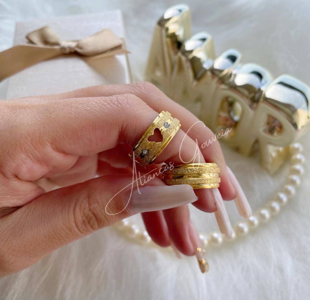 mod-jat-cor-2-2.jpg Par de Alianças Banhadas Coração com Pedras Jateada - Imagem 1